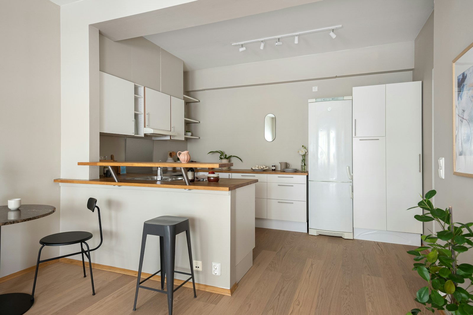 A kitchen with a table and stools in it